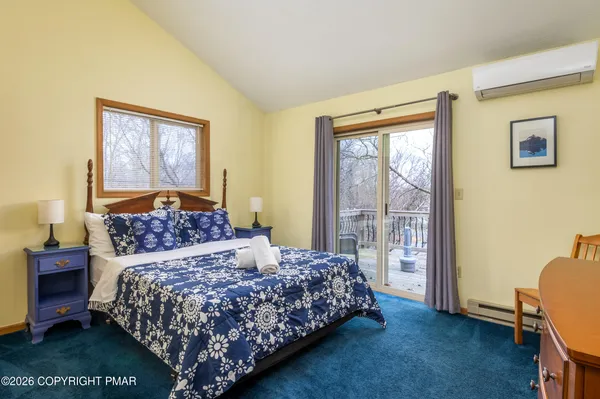 a bedroom with a large bed and a window