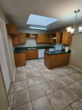 a kitchen with stainless steel appliances granite countertop a sink and a stove