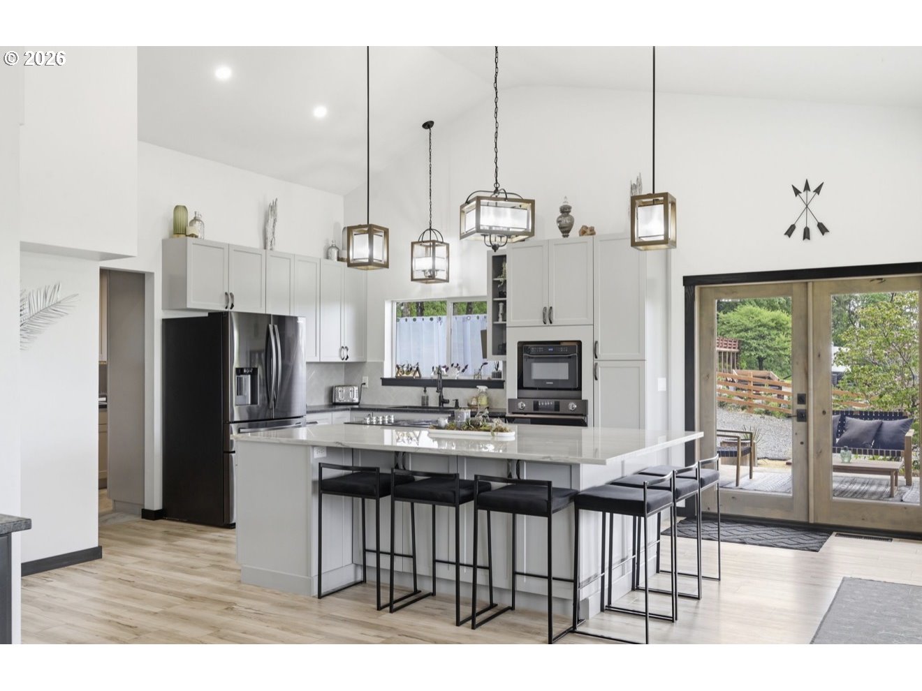 33192 Wilkins Road Eugene, OR 97408 - Photo 16 of 35 a kitchen with stainless steel appliances kitchen island granite countertop a table chairs and a view of living room