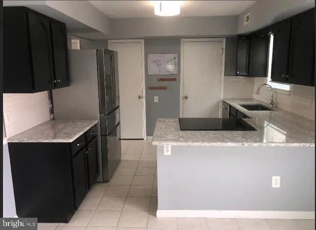 an entryway with wooden floor mirror and window