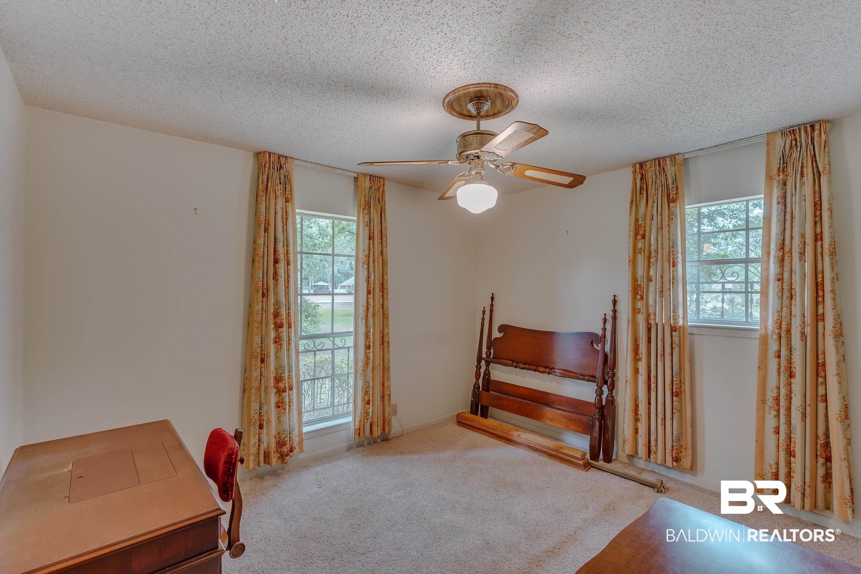 5151 McCrary Road Semmes, AL 36575 - Photo 51 of 62 Bedroom with multiple windows, carpet floors, a textured ceiling, and a ceiling fan