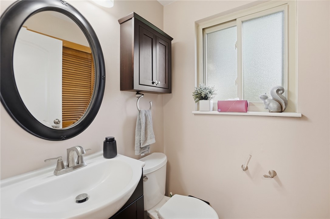 150 Littlejohn Road Troy, OH 45373 - Photo 17 of 40 This bathroom features a sleek vanity, a modern mirror, and a window with frosted glass.