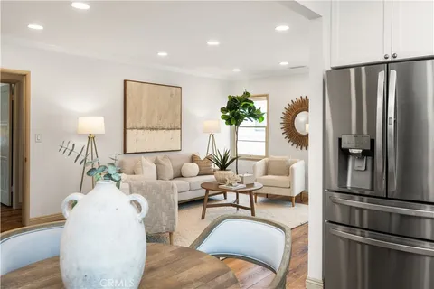 a living room with furniture fireplace and a window