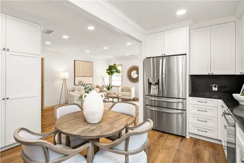 a kitchen with refrigerator and cabinets