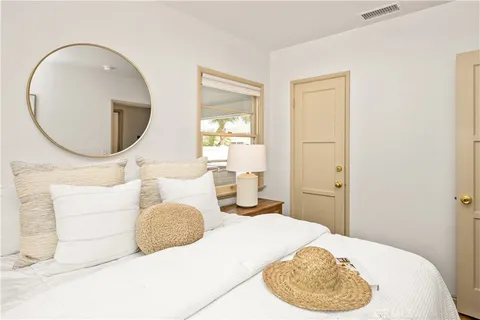 a bedroom with a bed and a mirror