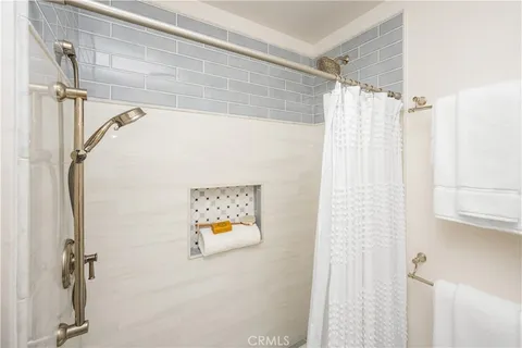 a bathroom with a shower and a shower curtain