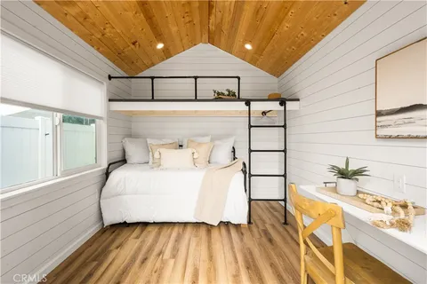 a bedroom with a bed and a view of walk in closet