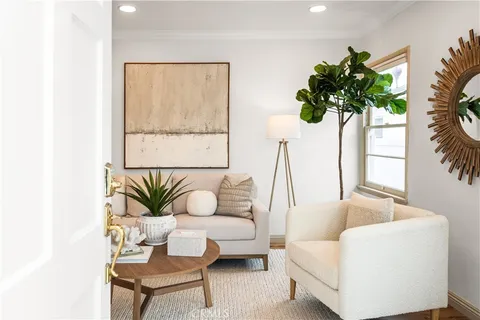 a living room with furniture and a potted plant
