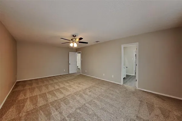 a view of an empty room with a fan