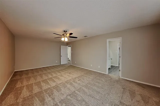 a view of an empty room with a fan