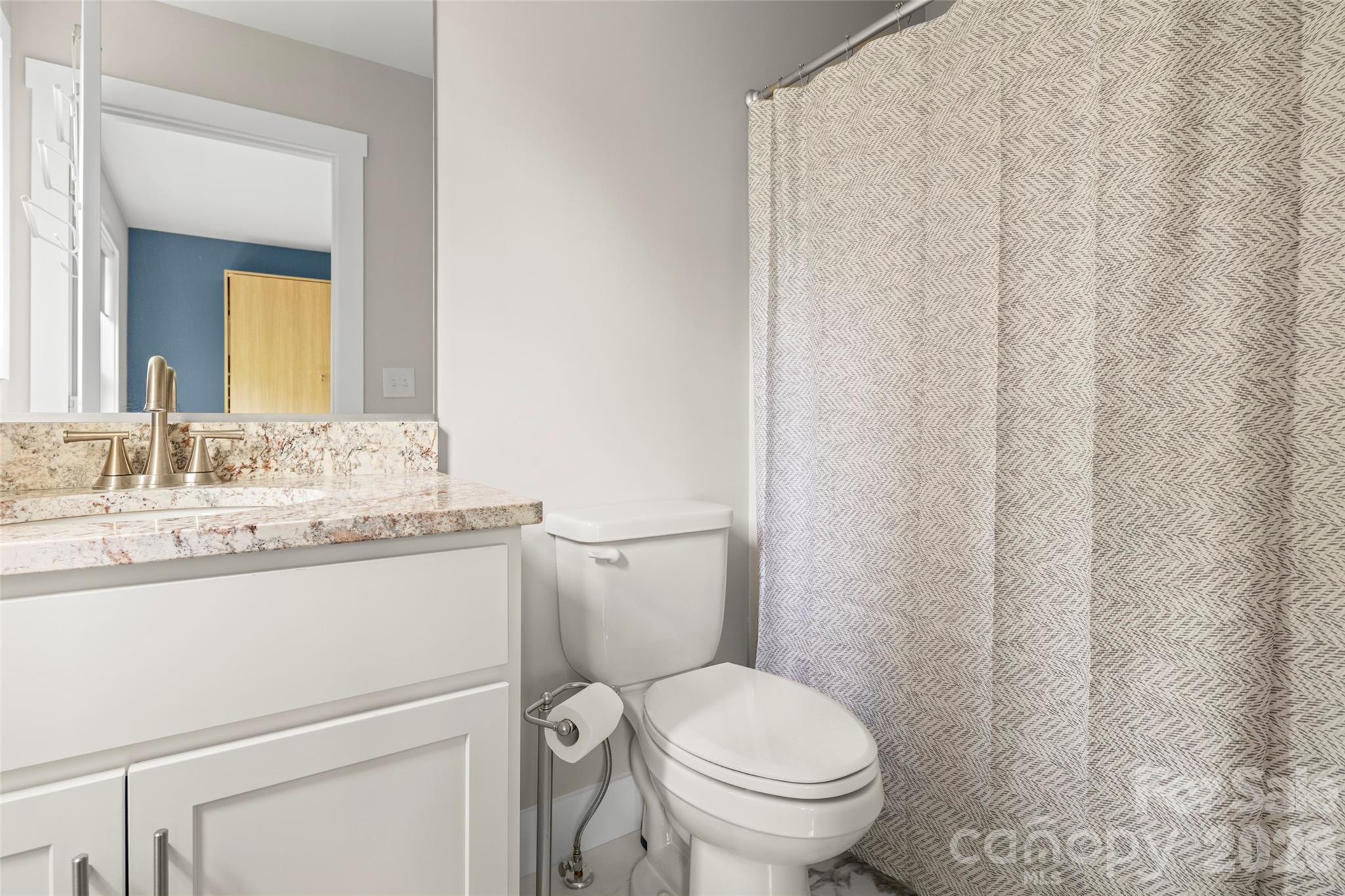 52 Wheeler Road Weaverville, NC 28787 - Photo 17 of 21 a bathroom with a granite countertop sink toilet and mirror