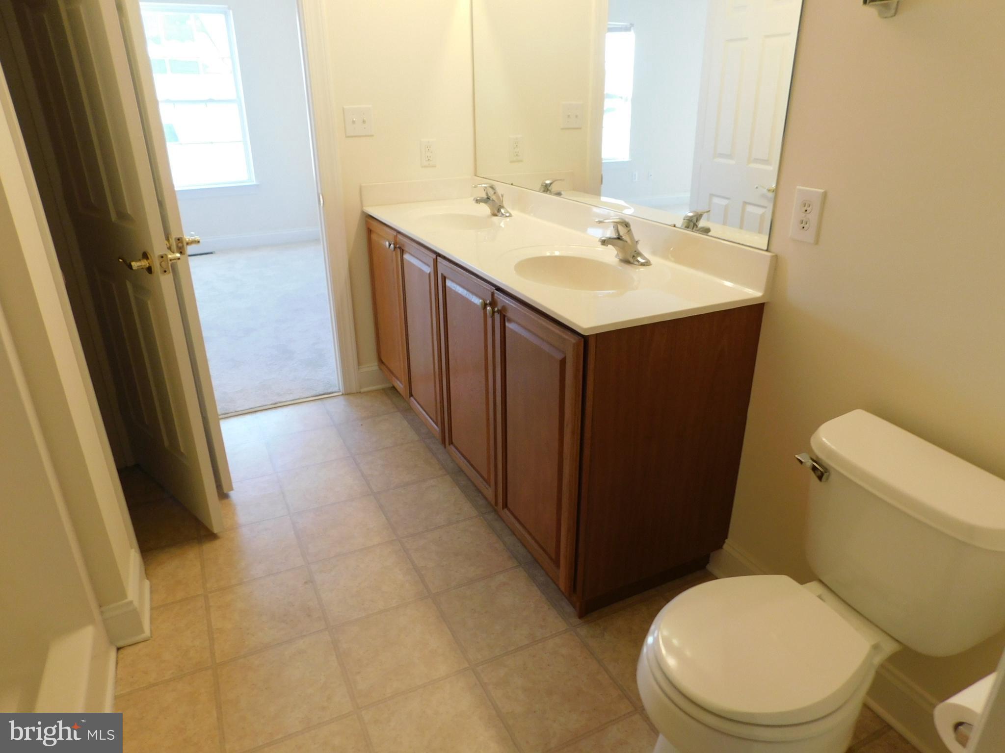 70 Sugar Maple Road Barto, PA 19504 - Photo 7 of 14 a bathroom with a sink a toilet a mirror and vanity