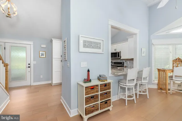 a living room with furniture a rug a fireplace and a large window