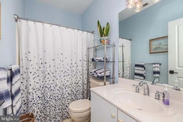a view of a hallway with wooden floor and entryway