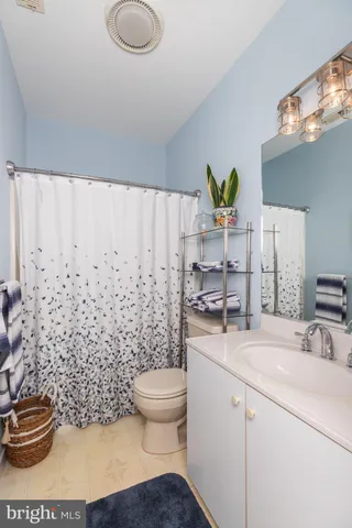 a view of a livingroom with wooden floor and a hallway