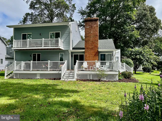 a front view of a house with a yard table and chairs
