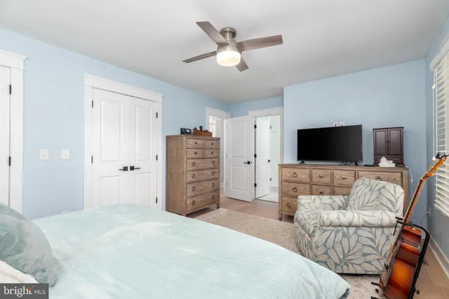 a spacious bathroom with a granite countertop sink a toilet a mirror and a window