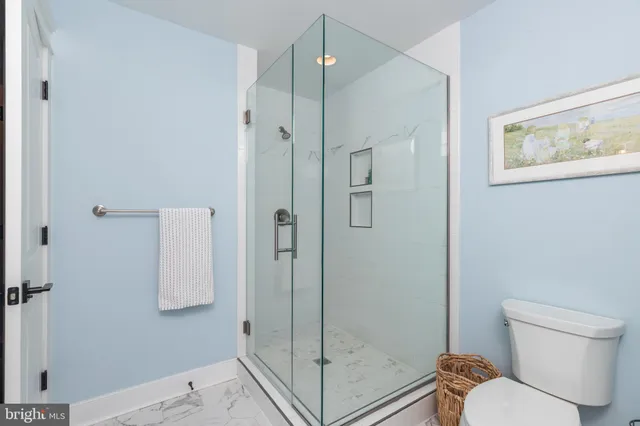 a bedroom with a bed and glass window