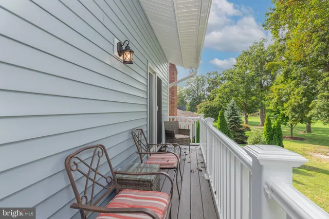 a view of a building with sitting area and garden