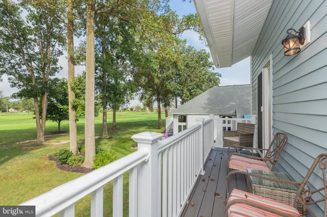 a view of a patio with a table chairs and a yard