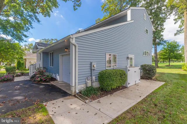 an aerial view of residential houses with outdoor space and trees