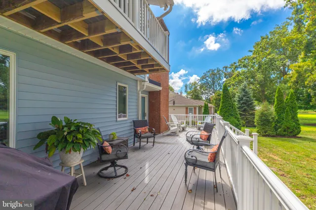 an aerial view of a house with a yard lake outdoor seating and mountain view