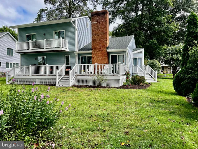 a front view of a house with a garden and plants