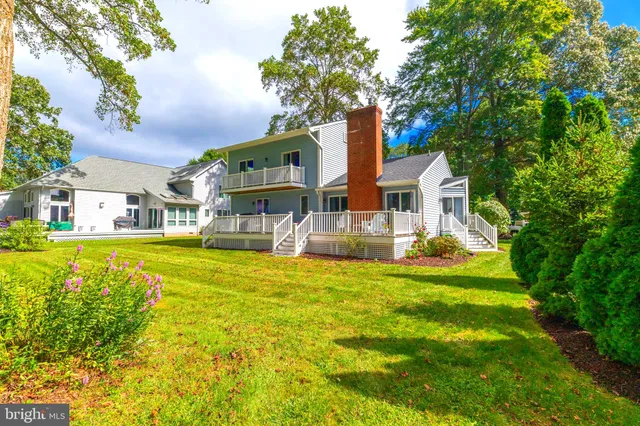 a front view of house with yard and swimming pool