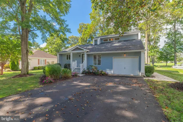 a view of a house with a yard and garden