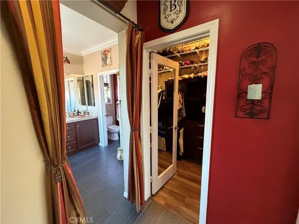 a view of a hallway and a livingroom with furniture