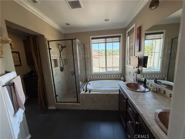 a bathroom with a granite countertop sink mirror vanity and a bathtub