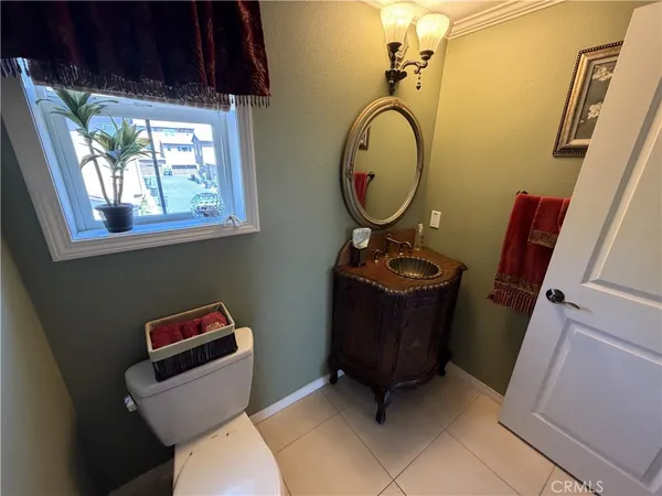 a bathroom with a toilet a sink and a mirror