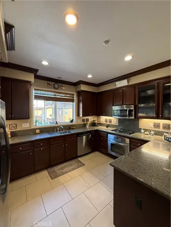 a large kitchen with granite countertop lots of counter space and sink