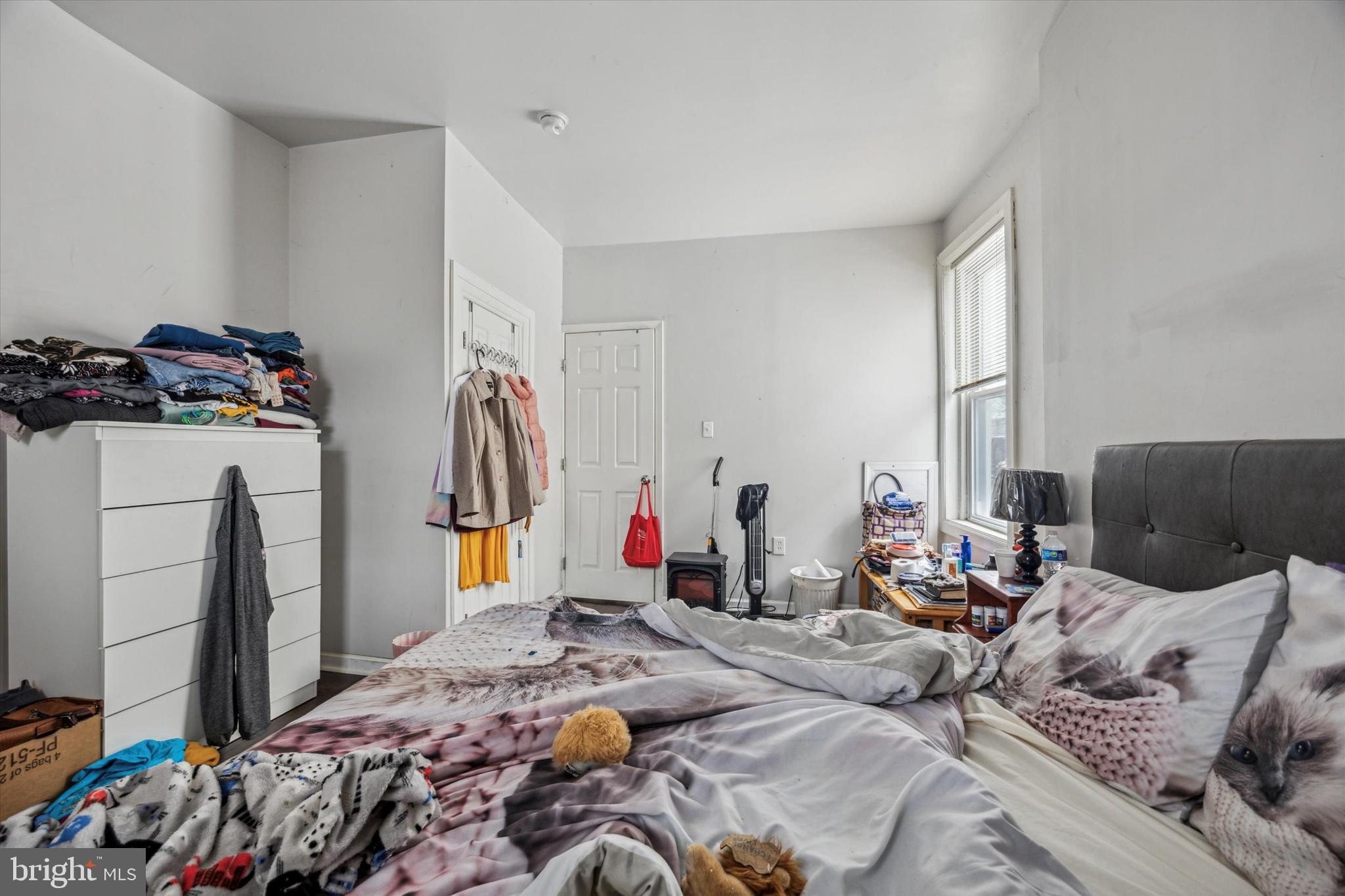 5739 Springfield Avenue Philadelphia, PA 19143 - Photo 13 of 16 a bed room with a bed and a couch