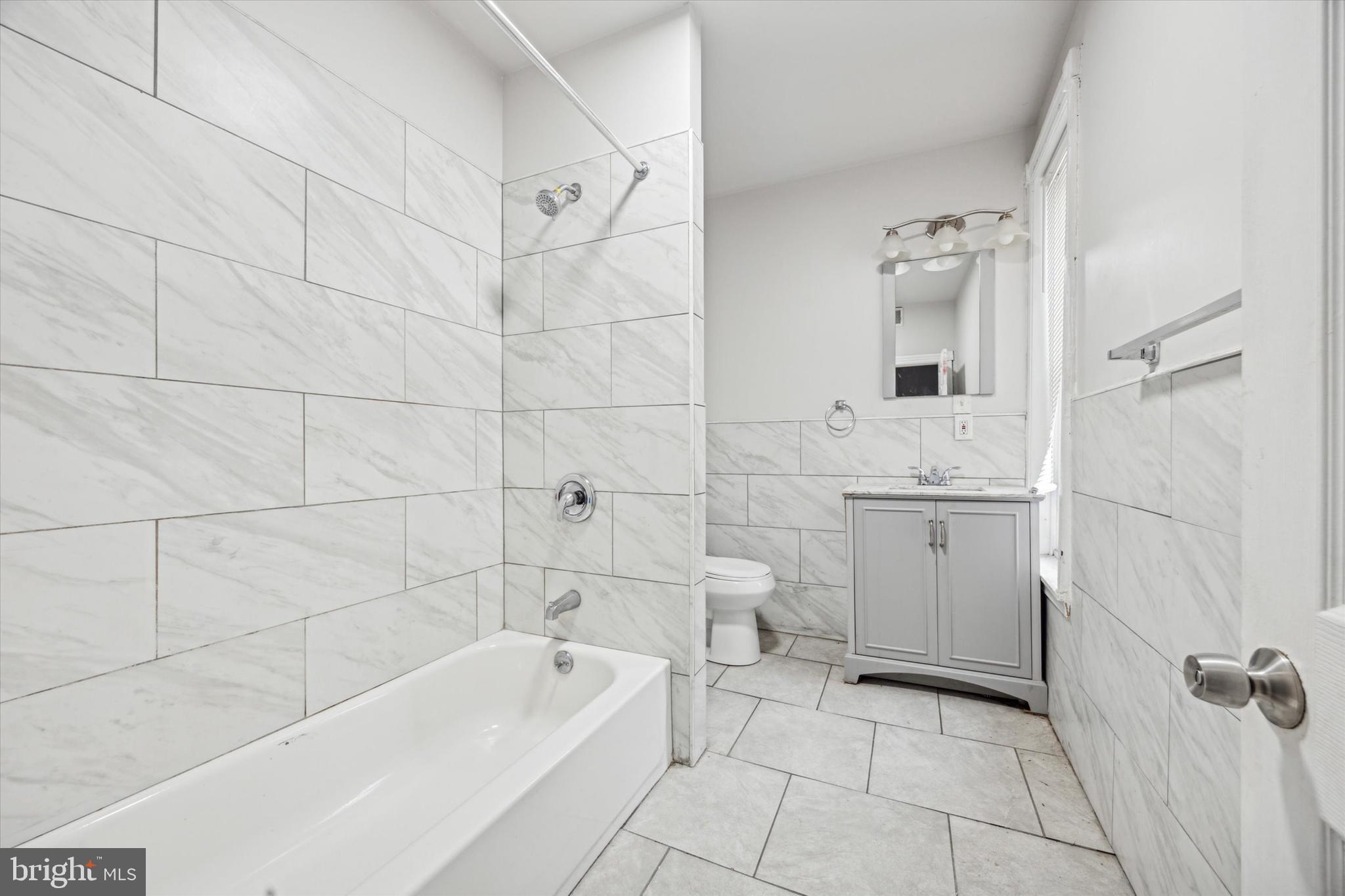 5739 Springfield Avenue Philadelphia, PA 19143 - Photo 6 of 16 a bathroom with a sink a toilet and shower