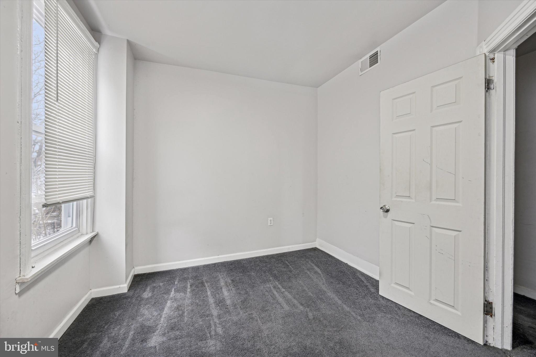 5739 Springfield Avenue Philadelphia, PA 19143 - Photo 8 of 16 a view of an empty room with windows