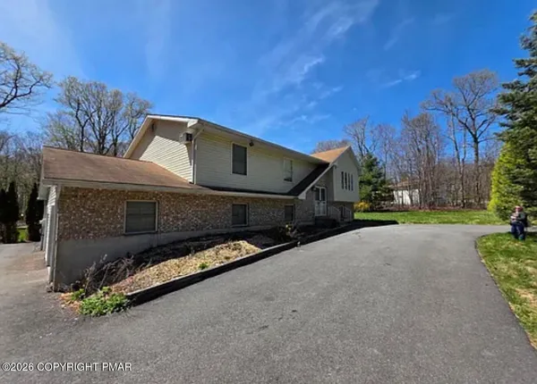 a view of a house with a yard