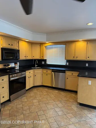 a kitchen with granite countertop a sink and a stove top oven