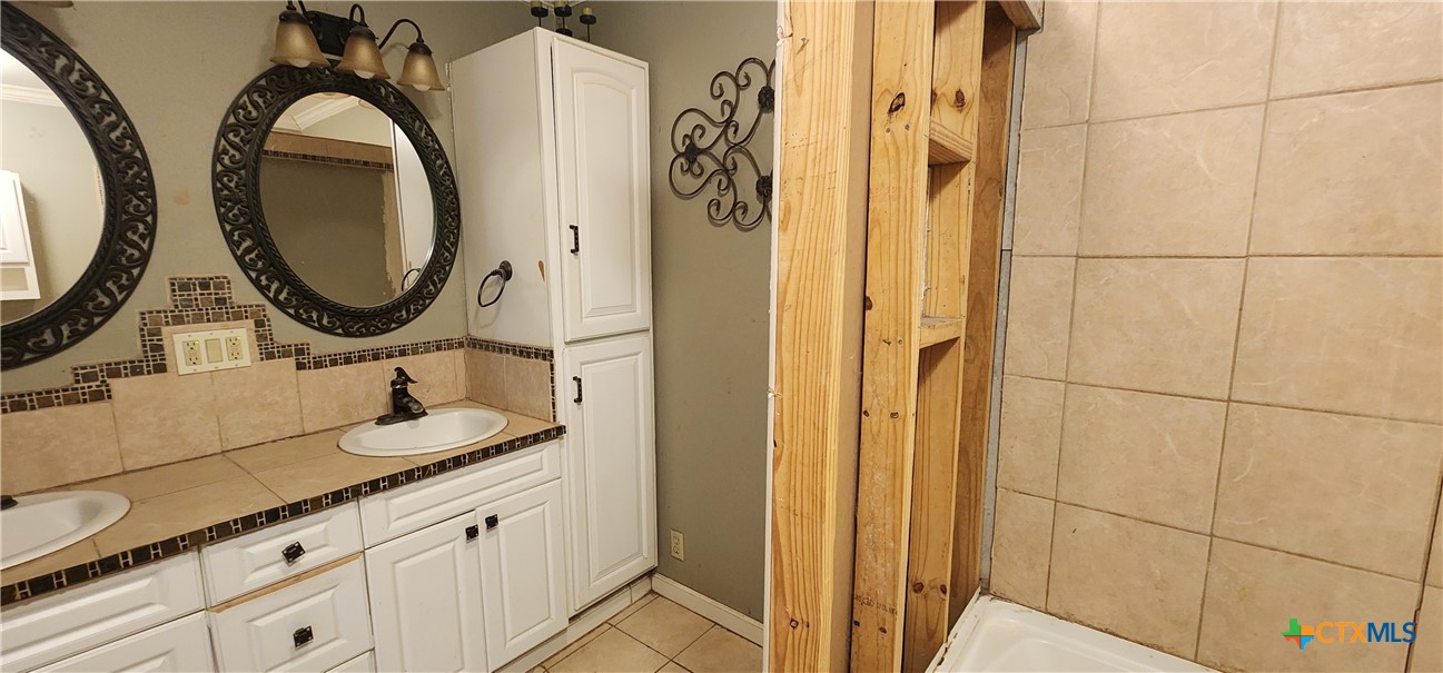 604 Davis Street Edna, TX 77957 - Photo 14 of 26 a bathroom with a sink and a mirror