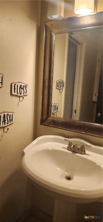 604 Davis Street Edna, TX 77957 - Photo 17 of 26 a bathroom with a sink and a mirror