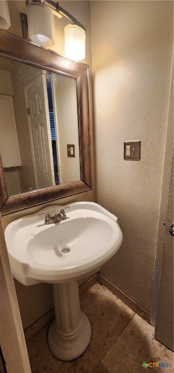 604 Davis Street Edna, TX 77957 - Photo 19 of 26 a bathroom with a sink and a mirror
