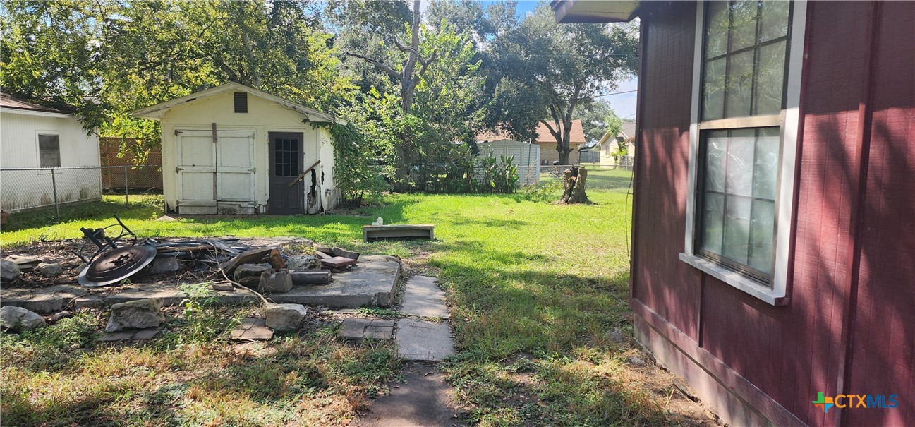 604 Davis Street Edna, TX 77957 - Photo 25 of 26 a backyard of a house with yard and outdoor seating