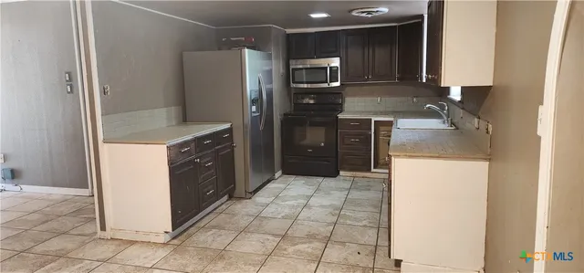 a kitchen with a sink stove and refrigerator