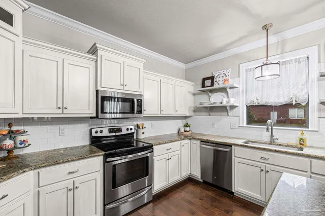 a room with furniture and view of kitchen