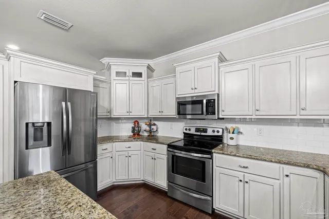 a bed sitting in a spacious bedroom next to a window
