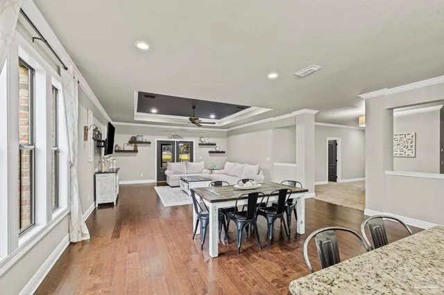 a living room with furniture and a air conditioner vent