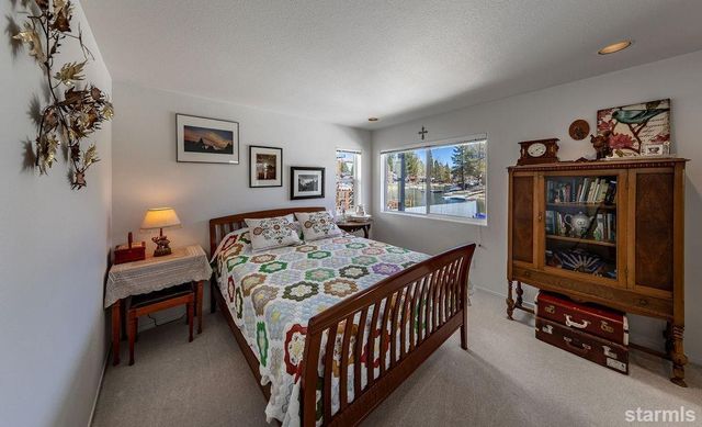 a bedroom with a bed a dresser and book shelf