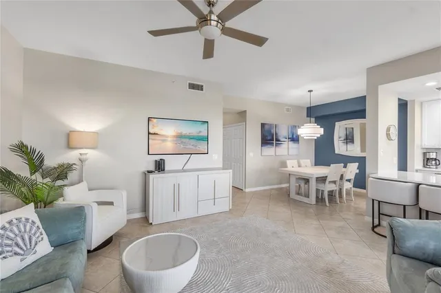 a view of a dining room with furniture a chandelier and wooden floor