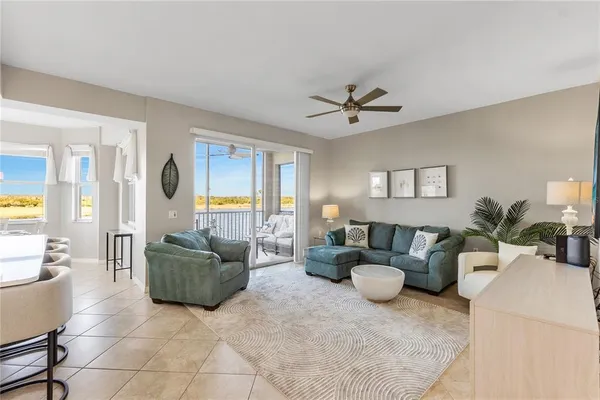 a living room with furniture a chandelier and a rug