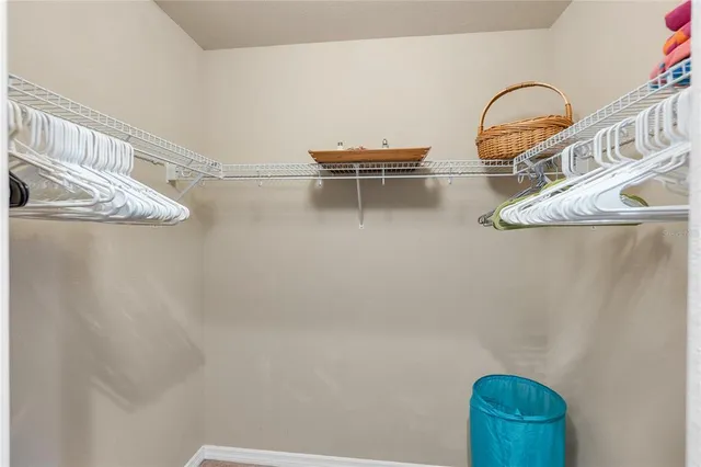 a view of a bedroom with wooden floor
